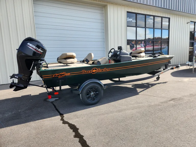 Slide: The Image of 2025 Tracker Bass Tracker Classic XL Limited boat parked outside a building. - 5