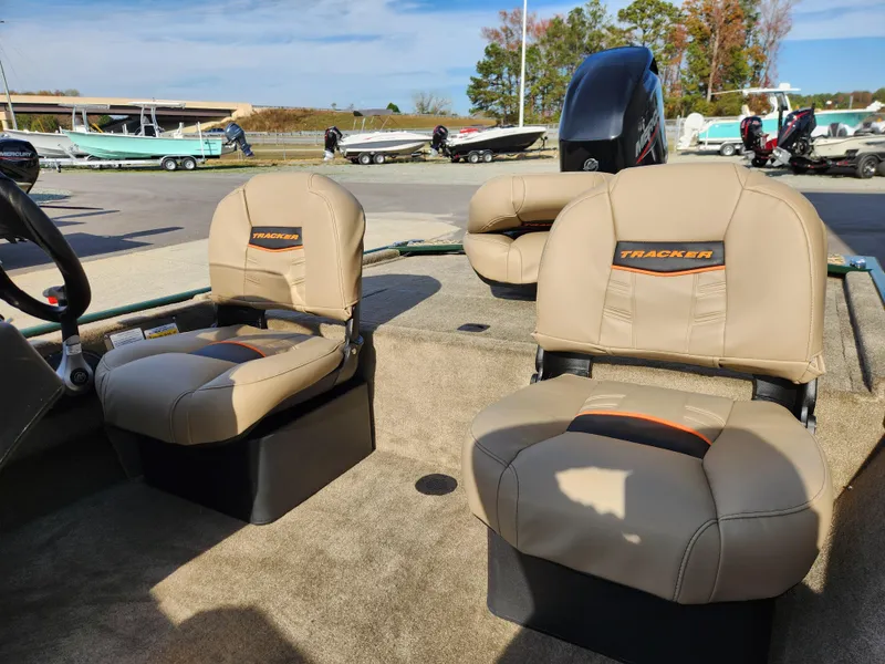 Slide: The Image of 2025 Tracker Bass Tracker Classic XL Limited boat seats in a marina setting. - 8
