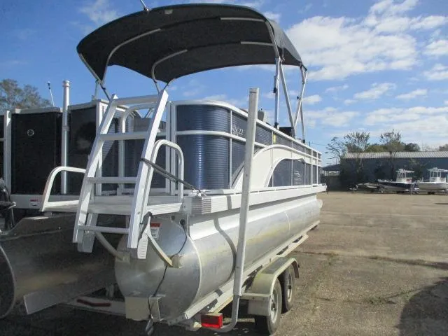 Slide: The Image of 2020 Bennington SFX22 pontoon boat on trailer under blue sky. - 5