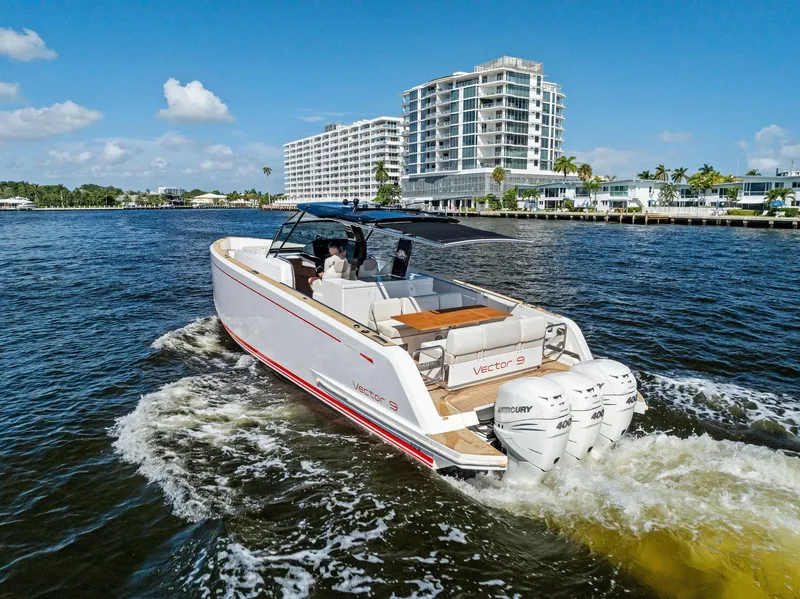 Slide: The Image of 2021 Pardo Yachts 38 cruising on a sunny day near modern waterfront buildings. - 18