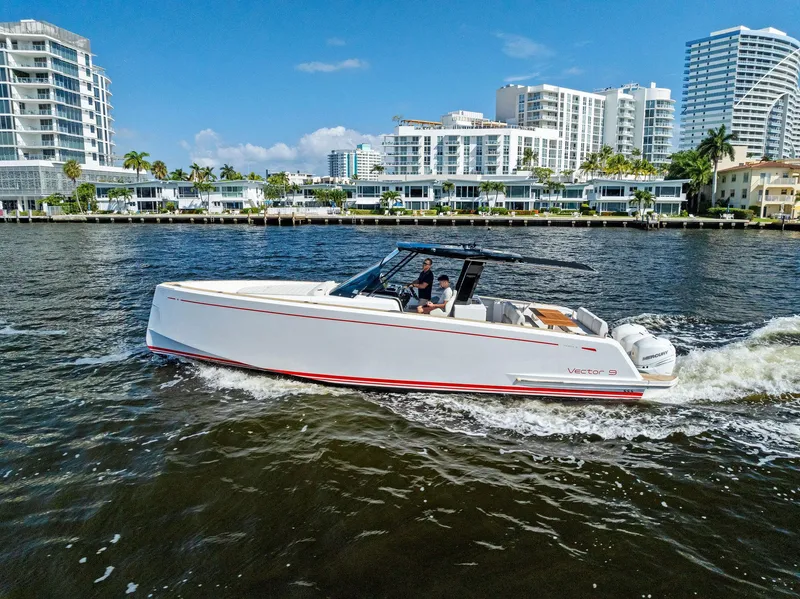 Slide: The Image of Pardo Yachts 38 cruising on water, modern cityscape in background, 2021 model. - 19