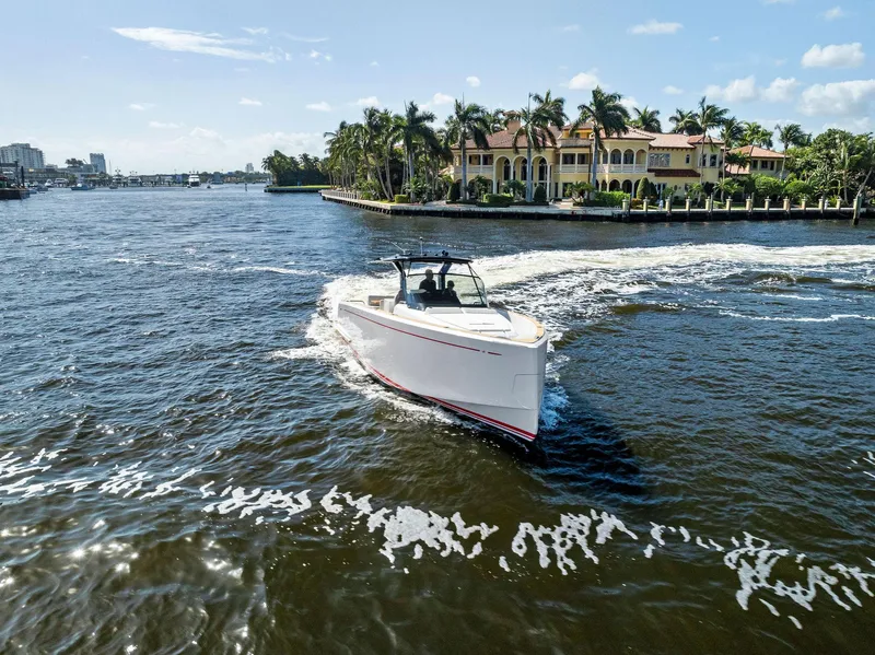 Slide: The Image of 2021 Pardo Yachts 38 cruising near luxury waterfront homes. - 22