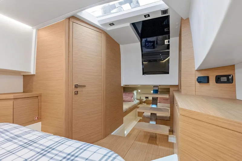 Slide: The Image of Interior of 2021 Pardo Yachts 38, featuring modern wood finishes and cozy sleeping area. - 26