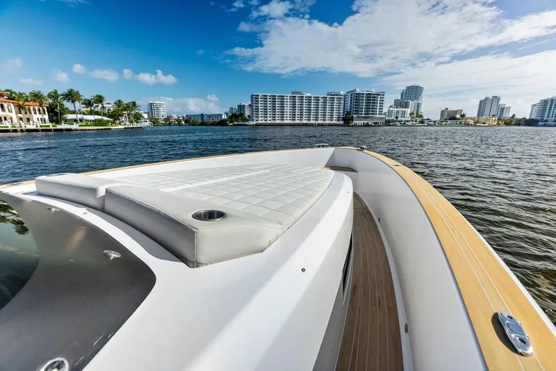 Slide: The Image of Pardo Yachts 38, 2021 model, cruising near modern waterfront buildings. - 31