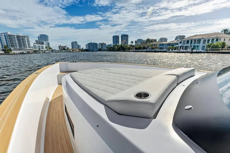 Slide: The Image of Pardo Yachts 38, 2021 model, cruising on a sunny waterfront with city skyline. - 32