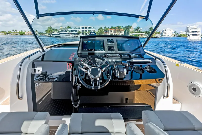 Slide: The Image of Helm of 2021 Pardo Yachts 38 with modern navigation equipment, docked by waterfront homes. - 47