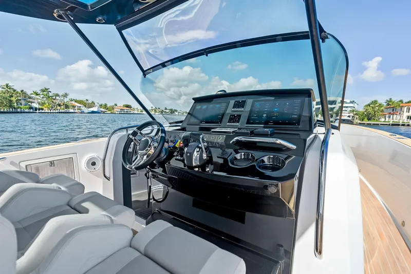 Slide: The Image of Pardo Yachts 38, 2021 model, sleek helm with modern controls on open water. - 48
