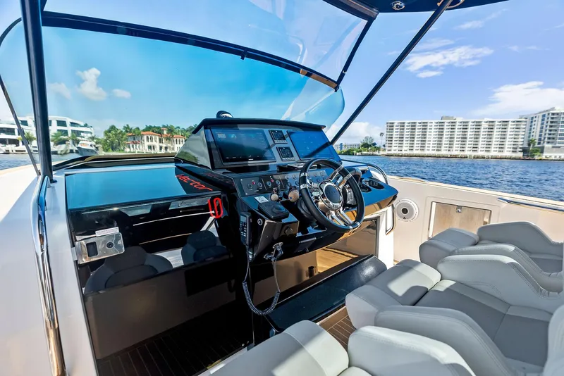 Slide: The Image of Luxury helm of 2021 Pardo Yachts 38 with modern controls and waterfront view. - 49