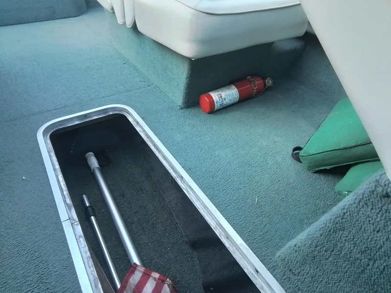 Slide: The Image of Interior of 1988 Sea Ray 20 Seville boat with fire extinguisher and storage compartment. - 14