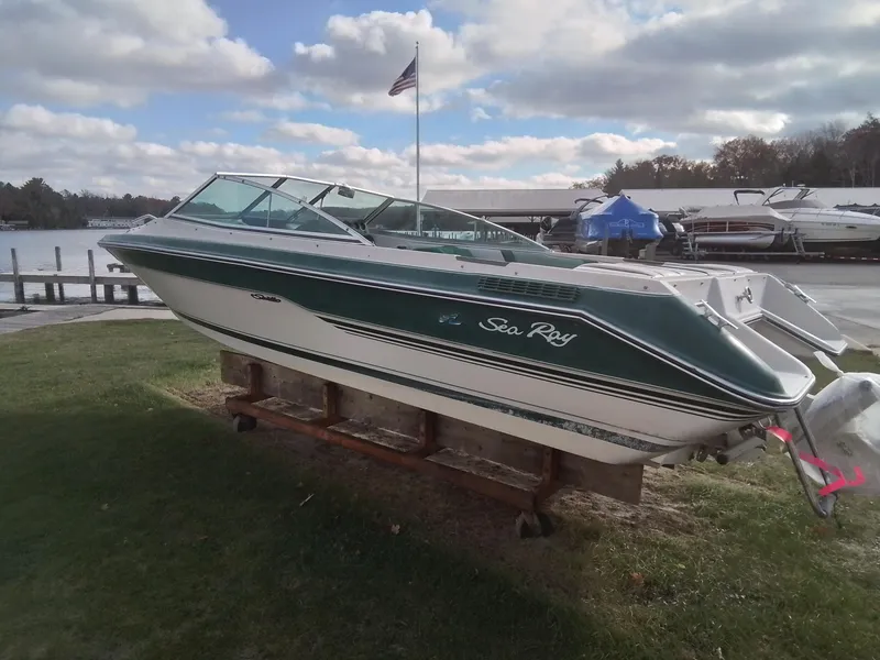 Slide: The Image of 1988 Sea Ray 20 Seville boat on display by a lakeside dock. - 2