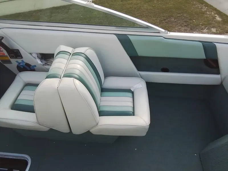 Slide: The Image of 1988 Sea Ray 20 Seville boat interior with striped seats and green accents. - 21