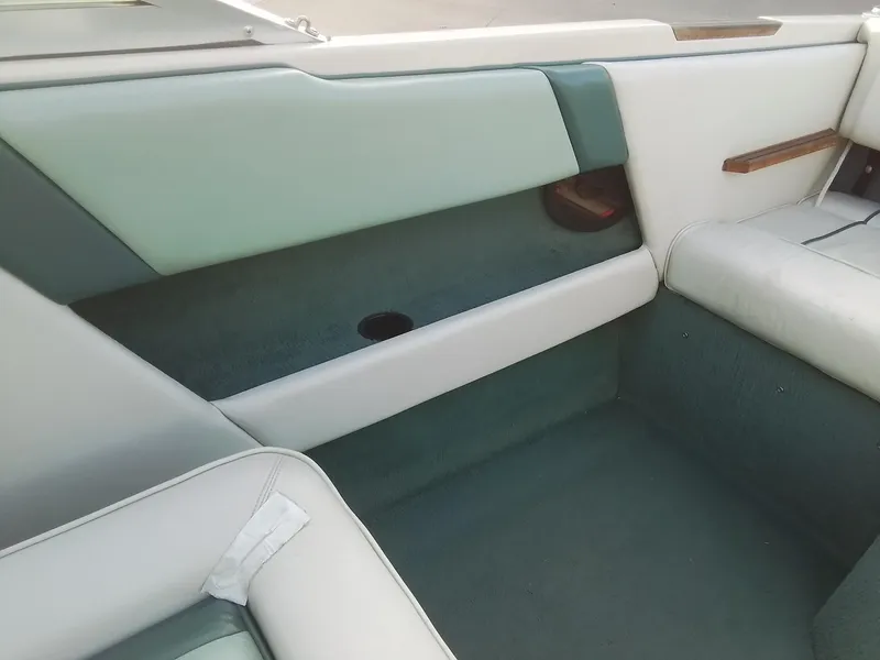 Slide: The Image of Interior of a 1988 Sea Ray 20 Seville boat with teal and white upholstery. - 22