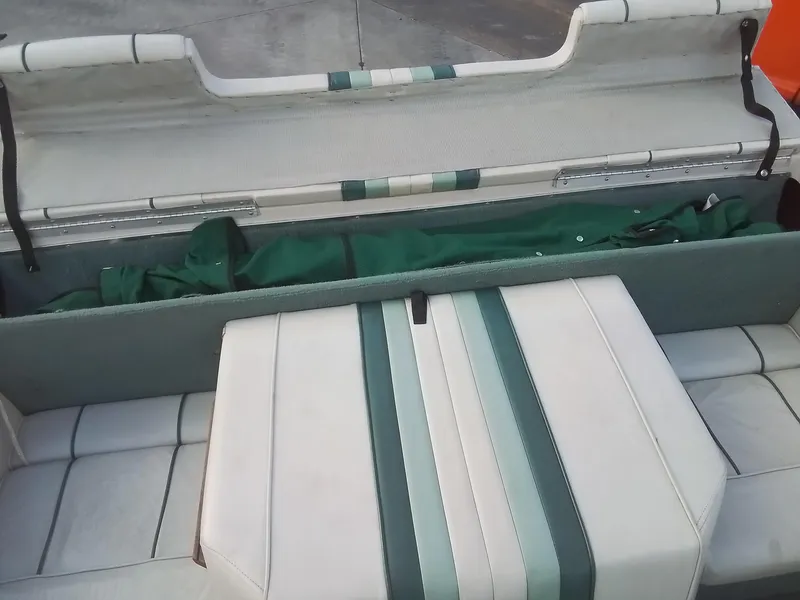 Slide: The Image of 1988 Sea Ray 20 Seville boat interior with green and white upholstery. - 24