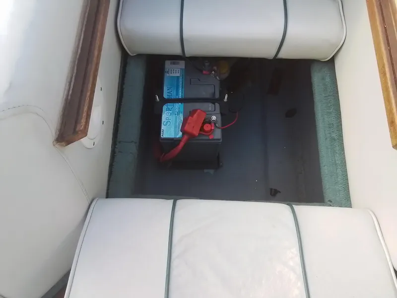 Slide: The Image of 1988 Sea Ray 20 Seville boat battery compartment with cushioned seating. - 26
