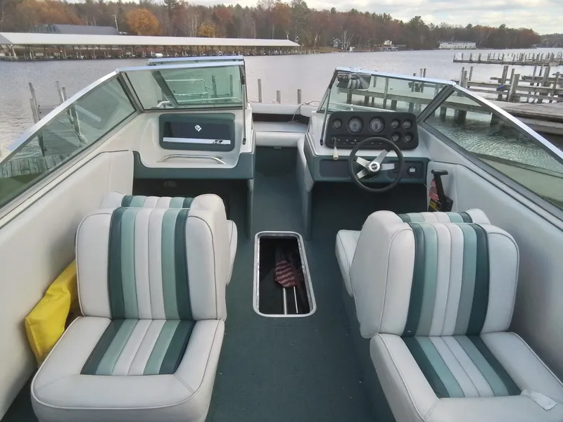 Slide: The Image of 1988 Sea Ray 20 Seville boat interior with striped seats and steering wheel. - 9