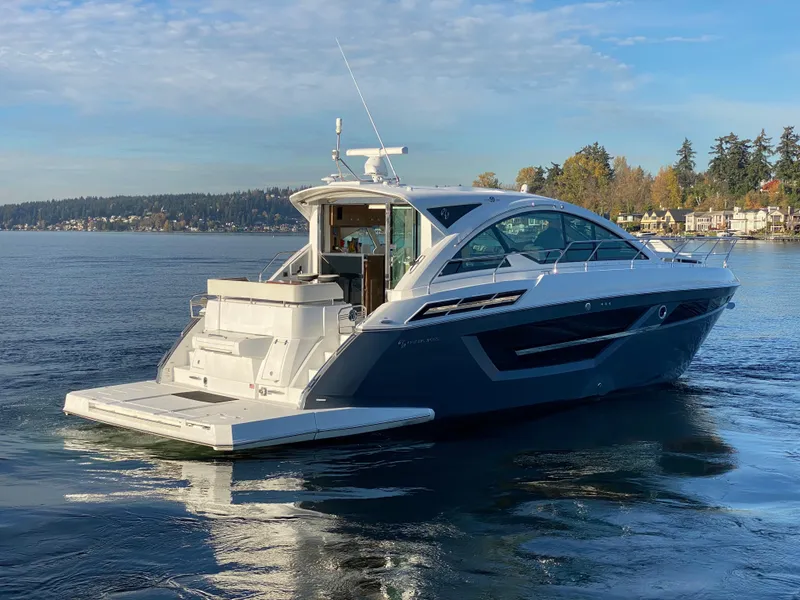 Slide: The Image of 2018 Cruisers Yachts 50 Cantius on serene water with scenic background. - 1