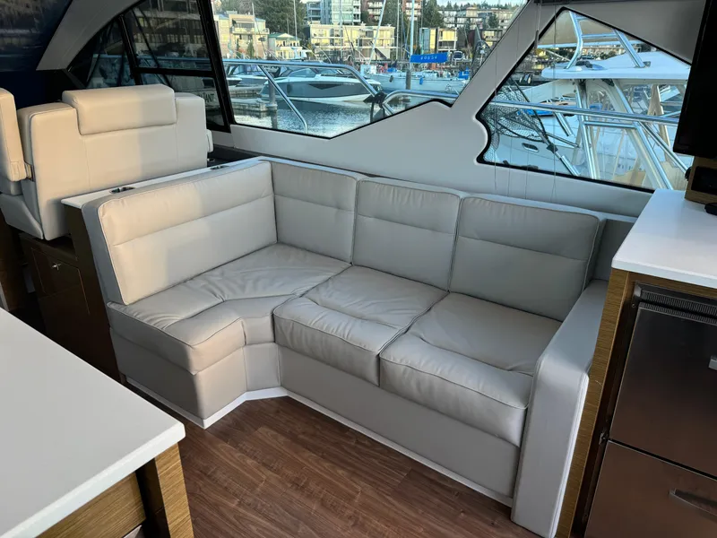 Slide: The Image of Luxurious interior of 2018 Cruisers Yachts 50 Cantius with plush seating and marina view. - 10