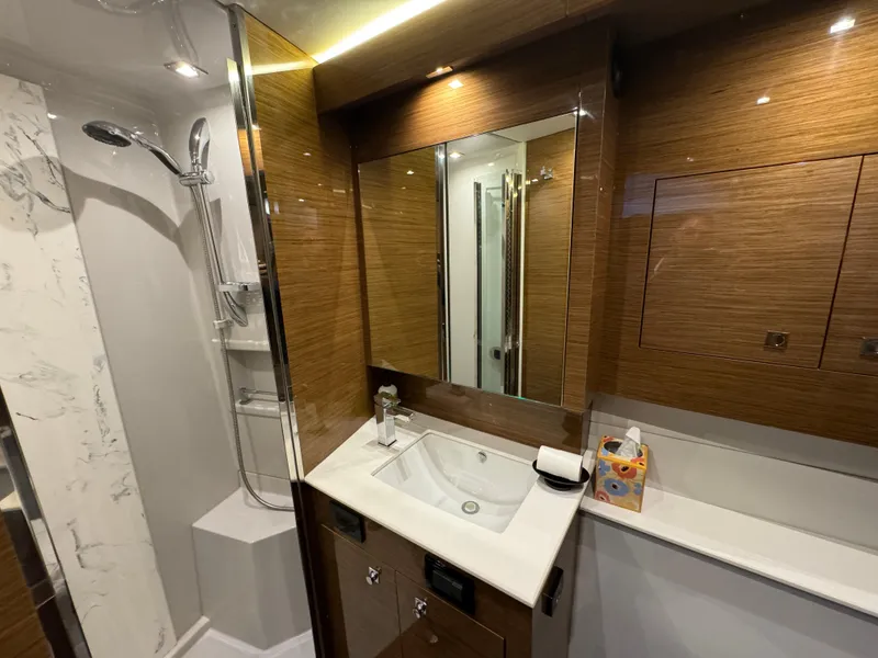 Slide: The Image of Luxurious bathroom in 2018 Cruisers Yachts 50 Cantius with modern fixtures and elegant wood finish. - 19