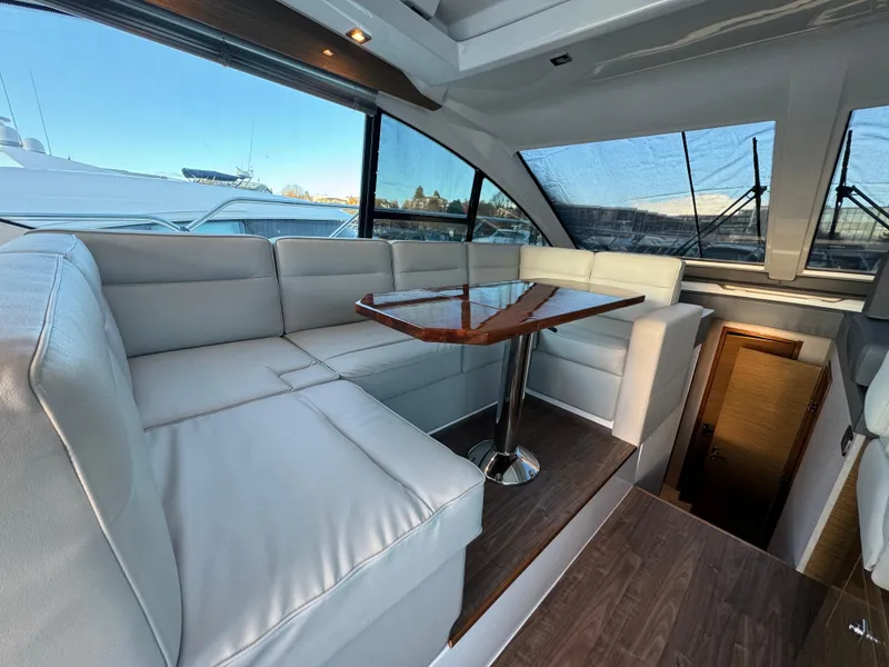 Slide: The Image of Luxurious interior of 2018 Cruisers Yachts 50 Cantius with elegant seating and wooden table. - 25