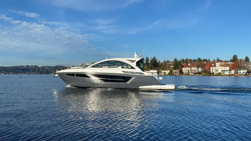 Slide: The Image of 2018 Cruisers Yachts 50 Cantius cruising on a serene lake under a clear blue sky. - 3