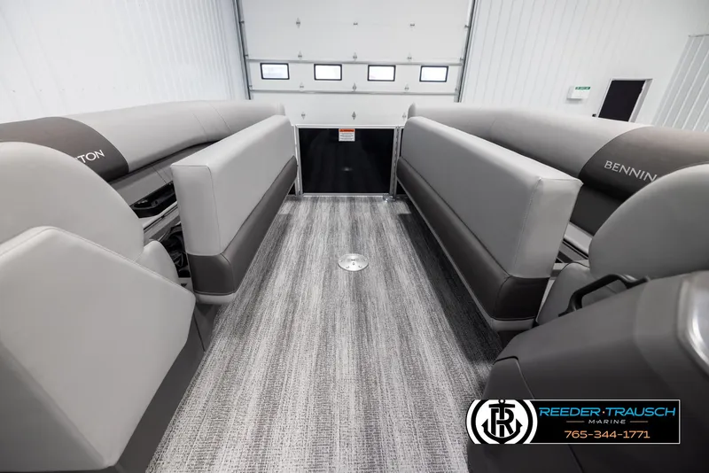 Slide: The Image of 2025 Bennington 23 SSRSE pontoon boat interior with gray seating and carpet flooring. - 19