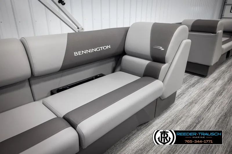 Slide: The Image of 2025 Bennington 23 SSRSE boat interior with gray seating, Reeder-Trausch Marine logo. - 23