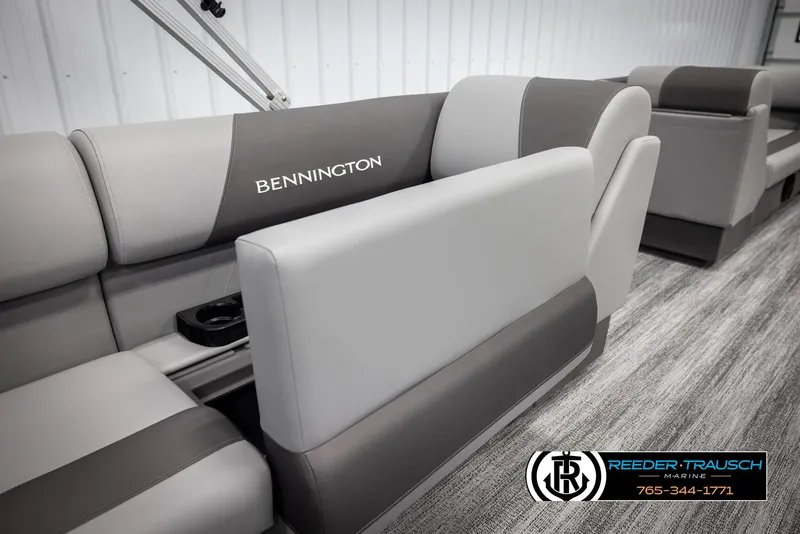 Slide: The Image of 2025 Bennington 23 SSRSE boat interior with gray seating and cup holders. - 24