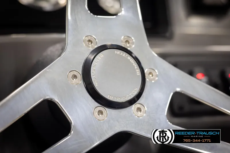 Slide: The Image of Steering wheel of 2025 Bennington 23 SSRSE boat, featuring sleek metallic design. - 27