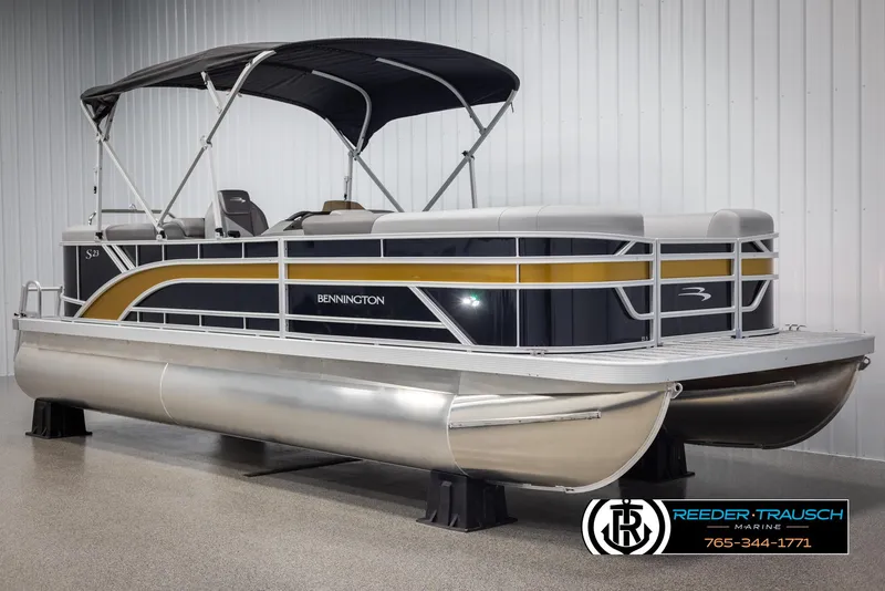 Slide: The Image of 2025 Bennington 23 SSRSE pontoon boat with canopy, displayed indoors at Reeder-Trausch Marine. - 3