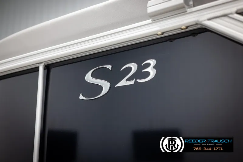 Slide: The Image of 2025 Bennington 23 SSRSE boat with "S23" emblem, Reeder-Trausch Marine branding. - 44