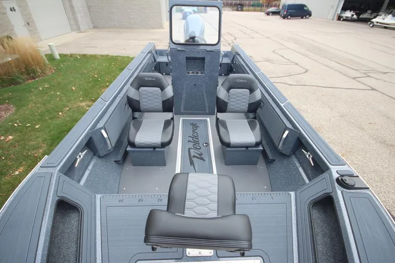 Slide: The Image of 2025 Weldcraft 200 Rebel Open boat interior with seating and steering console. - 1