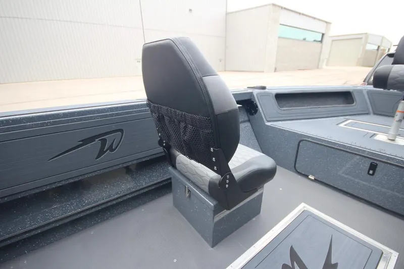Slide: The Image of 2025 Weldcraft 200 Rebel boat interior with black seating and storage compartments. - 14