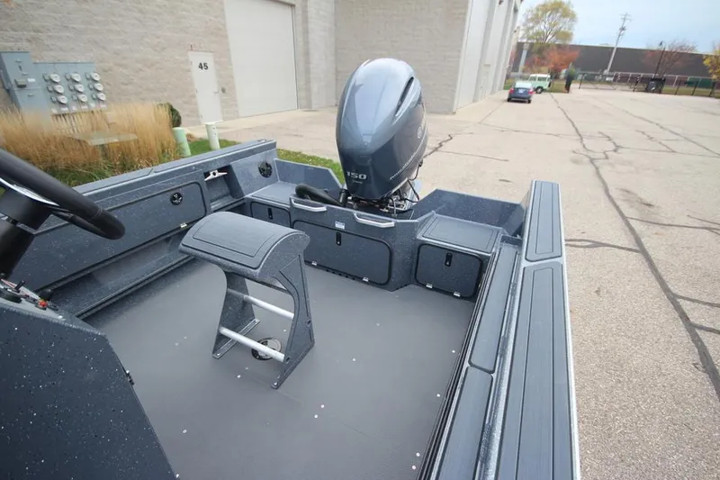 Slide: The Image of 2025 Weldcraft 200 Rebel Open boat with F150hp engine, parked outdoors. - 2