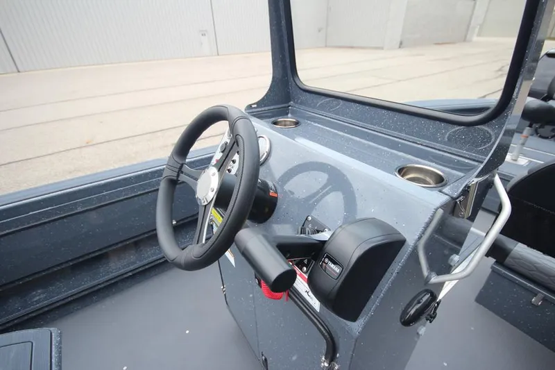 Slide: The Image of 2025 Weldcraft 200 Rebel boat cockpit with steering wheel and controls. - 20