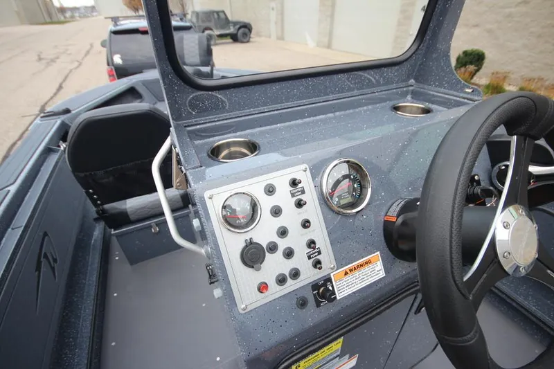Slide: The Image of 2025 Weldcraft 200 Rebel Open boat dashboard with controls and steering wheel. - 21