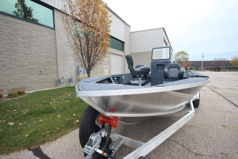 Slide: The Image of 2025 Weldcraft 200 Rebel Open boat on trailer, parked outside industrial building. - 5