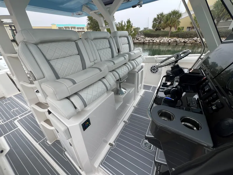 Slide: The Image of Luxurious interior of 2023 Pursuit 428 Sport boat with plush seating and modern controls. - 16