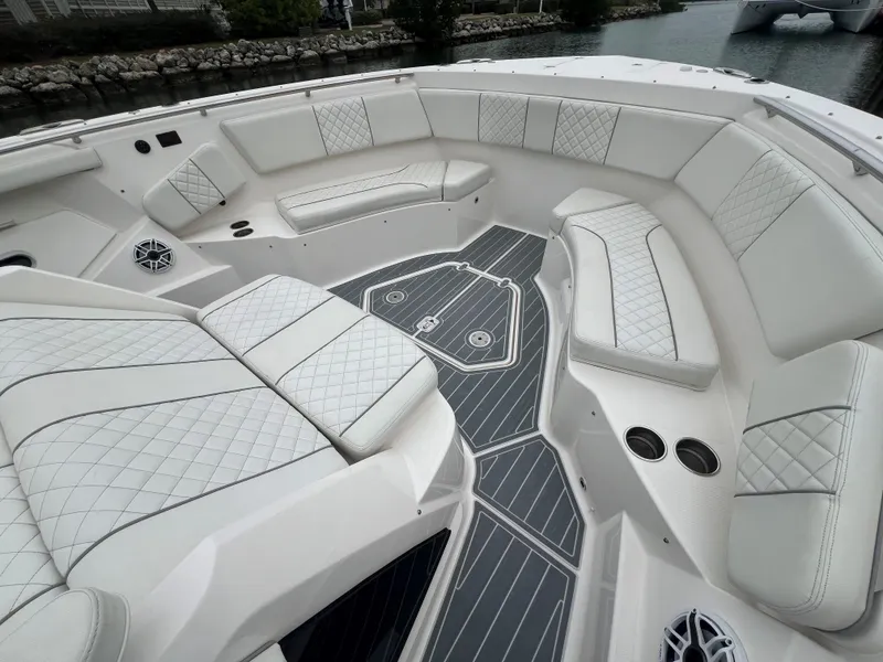 Slide: The Image of Luxurious seating on 2023 Pursuit 428 Sport boat with elegant white upholstery. - 17