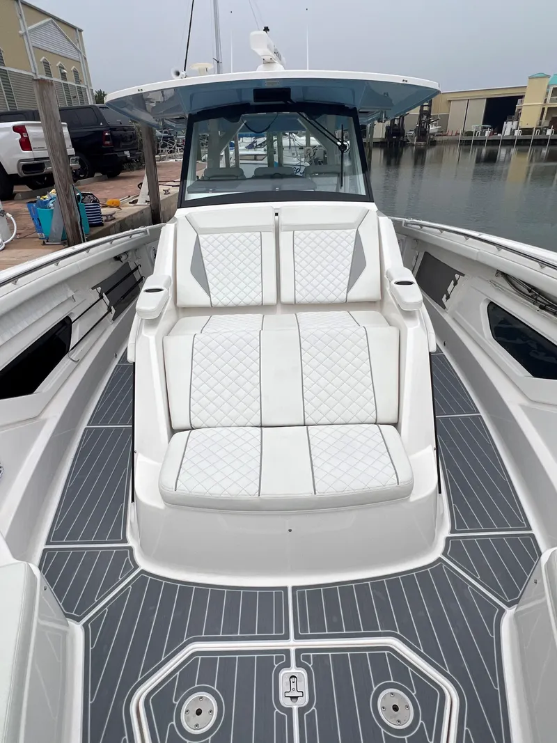 Slide: The Image of 2023 Pursuit 428 Sport boat with sleek deck and luxurious seating. - 19