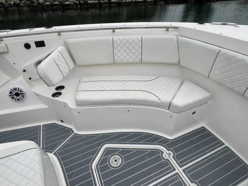 Slide: The Image of 2023 Pursuit 428 Sport boat with luxurious white seating and sleek deck design. - 20