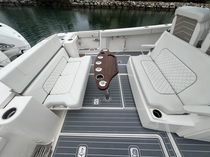 Slide: The Image of Luxurious seating area on 2023 Pursuit 428 Sport boat with elegant design. - 24