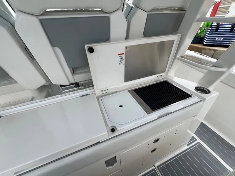 Slide: The Image of 2023 Pursuit 428 Sport boat interior with sleek kitchen amenities. - 26