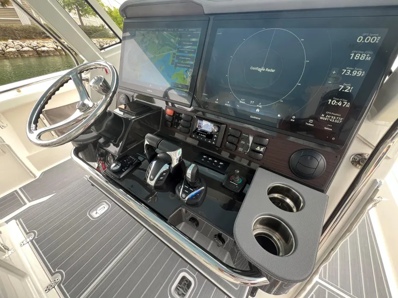 Slide: The Image of 2023 Pursuit 428 Sport boat dashboard with advanced navigation and control systems. - 27