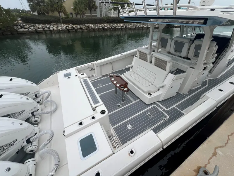 Slide: The Image of 2023 Pursuit 428 Sport boat with spacious deck and seating area. - 7