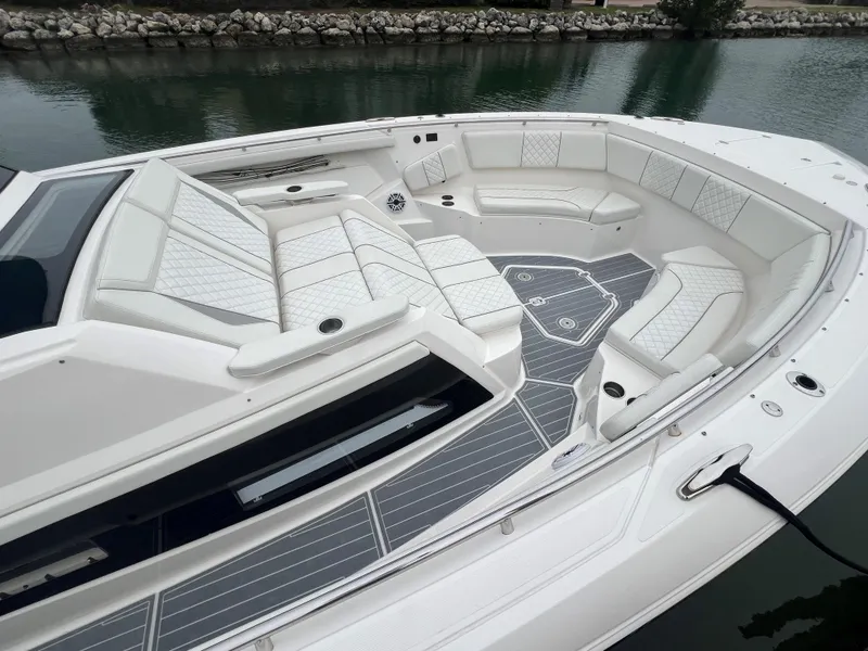 Slide: The Image of 2023 Pursuit 428 Sport boat with spacious seating and sleek design. - 9