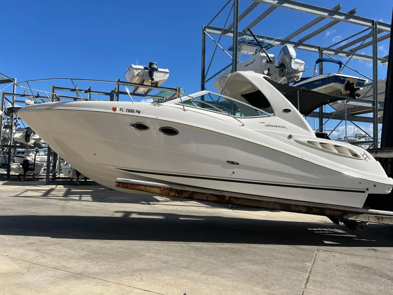 Slide: The Image of 2006 Sea Ray 290 Sundancer boat on a lift in a marina. - 1