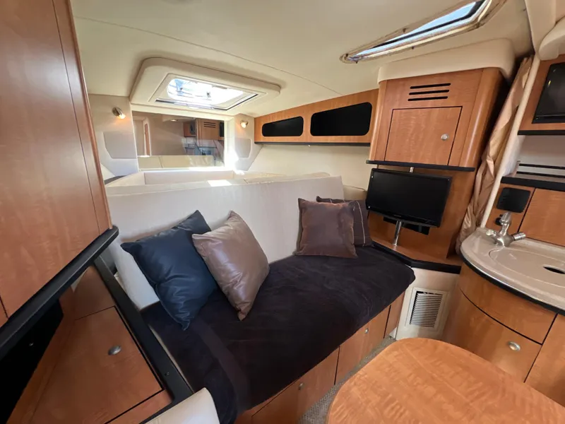 Slide: The Image of Luxurious 2006 Sea Ray 290 Sundancer cabin interior with cozy seating and modern amenities. - 11