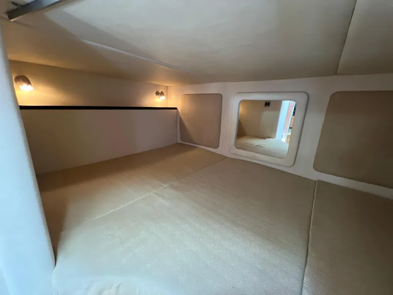 Slide: The Image of Interior cabin of 2006 Sea Ray 290 Sundancer with cozy bed and soft lighting. - 13