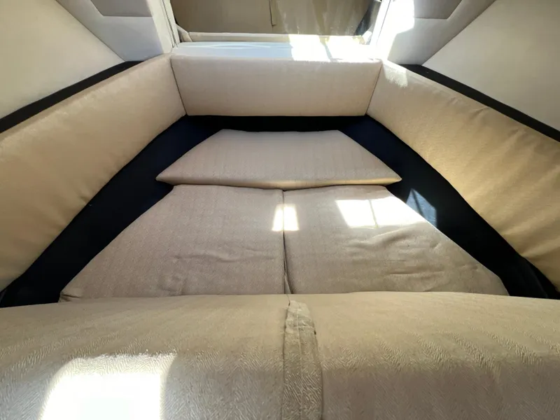 Slide: The Image of Interior cabin of 2006 Sea Ray 290 Sundancer with beige cushions. - 15