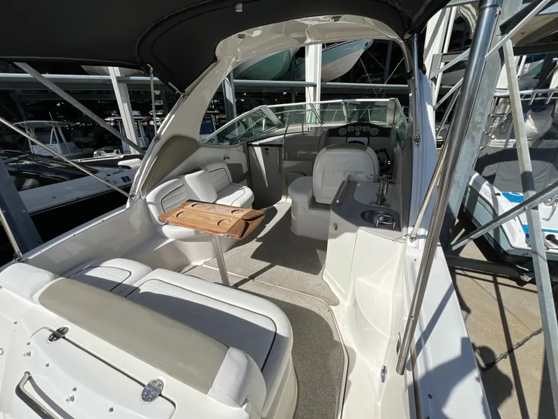 Slide: The Image of 2006 Sea Ray 290 Sundancer boat interior with seating and helm. - 16
